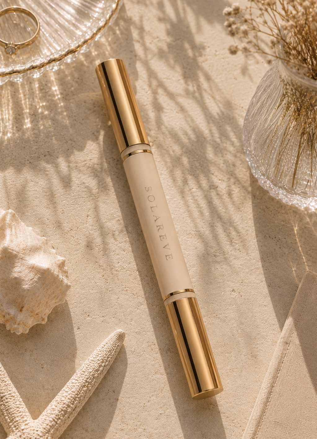 The SOLAREVE Lip Duo in ivory and gold resting on sun-warmed stone